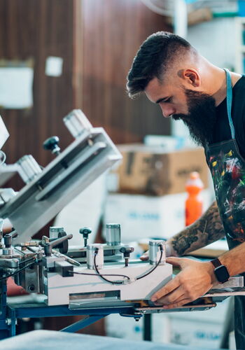 Man at screen printing machine